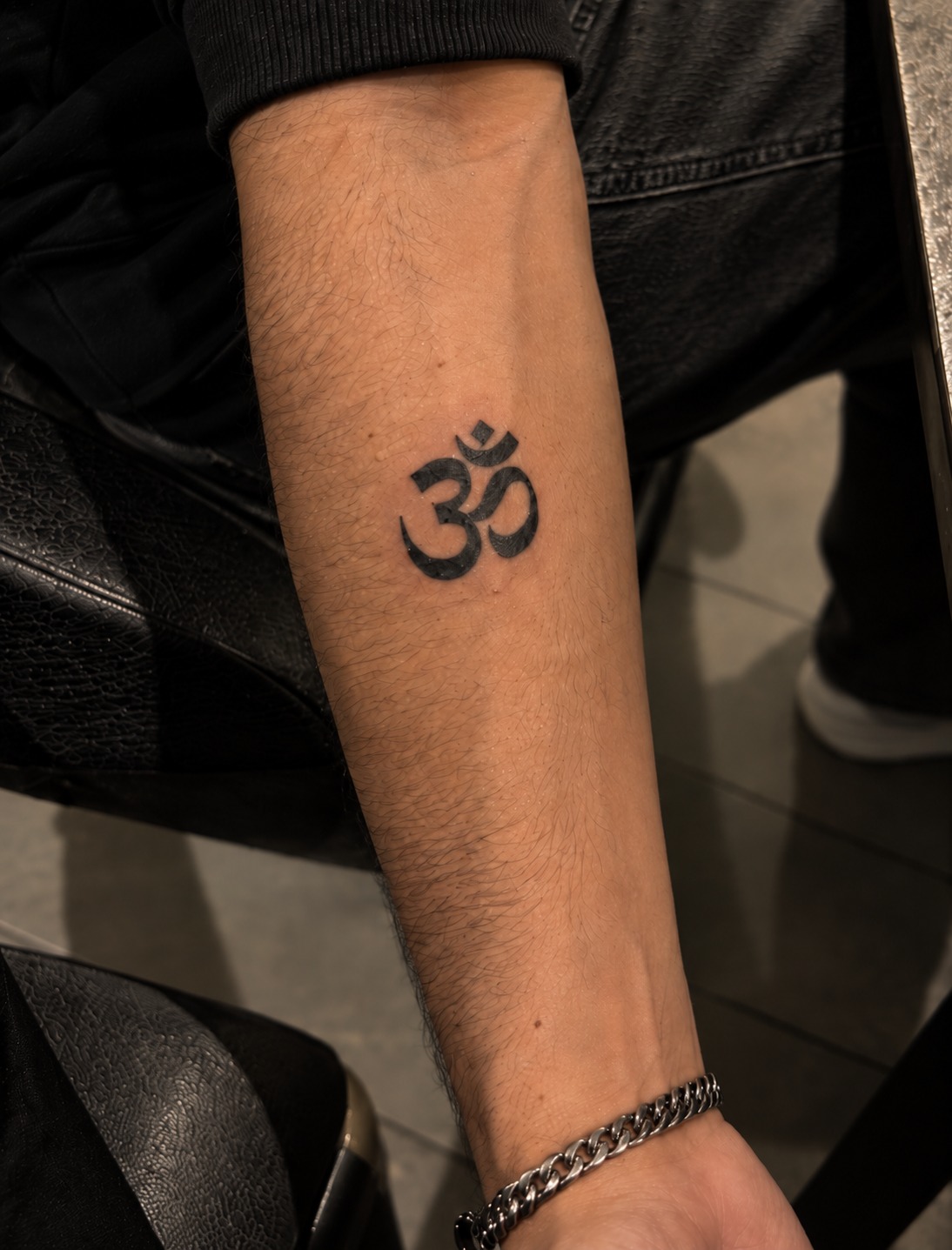 Om Essence semi-permanent tattoo shown on skin